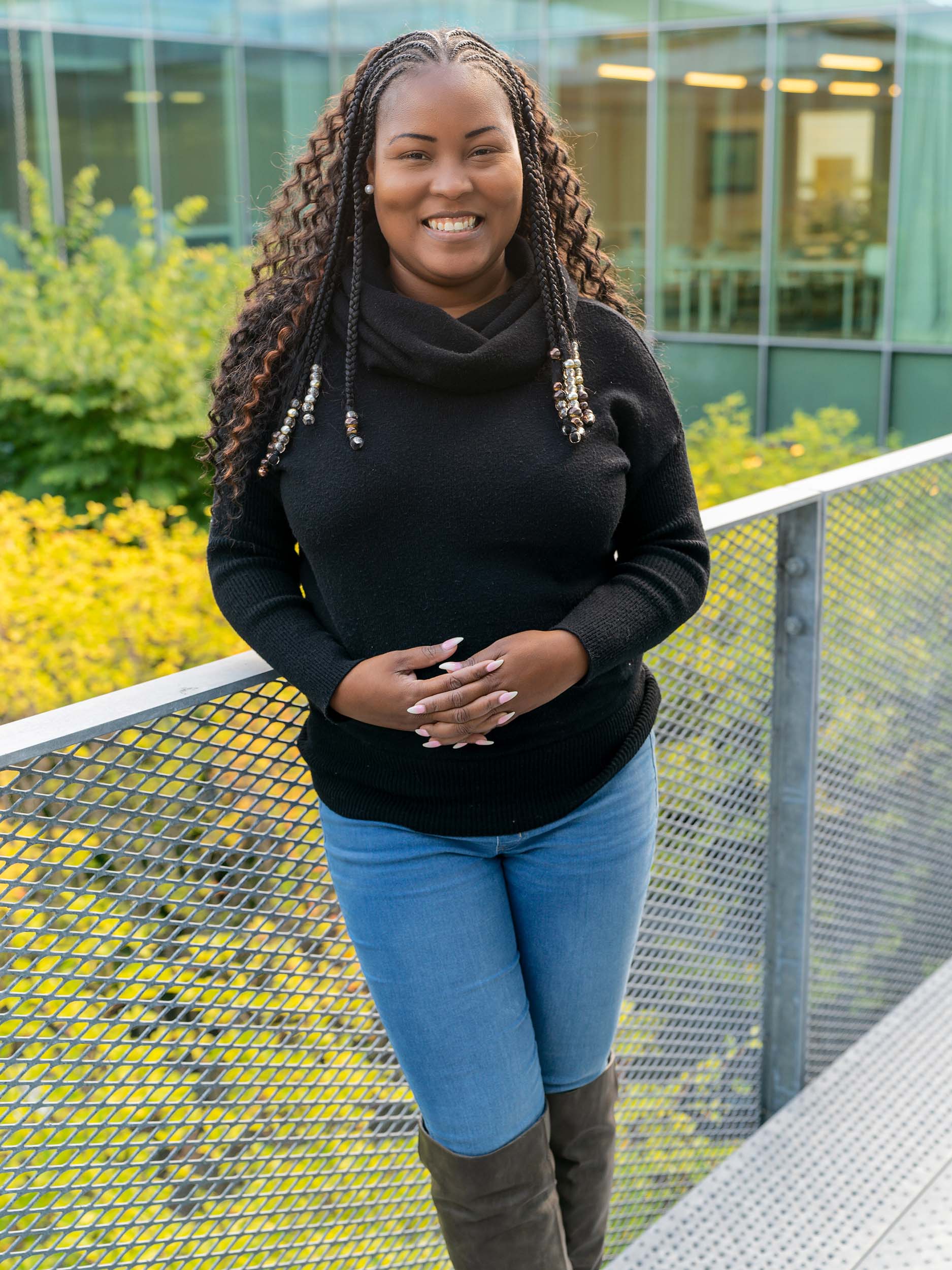 Shari Jones stands on the outside balcony of the Kaplan building