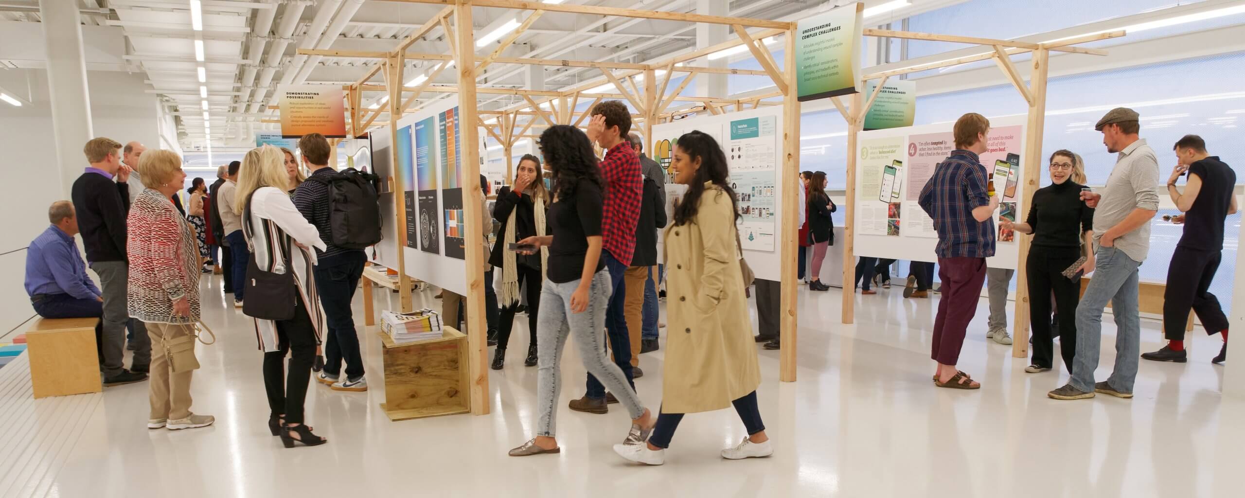 Students walking through the end of year show.