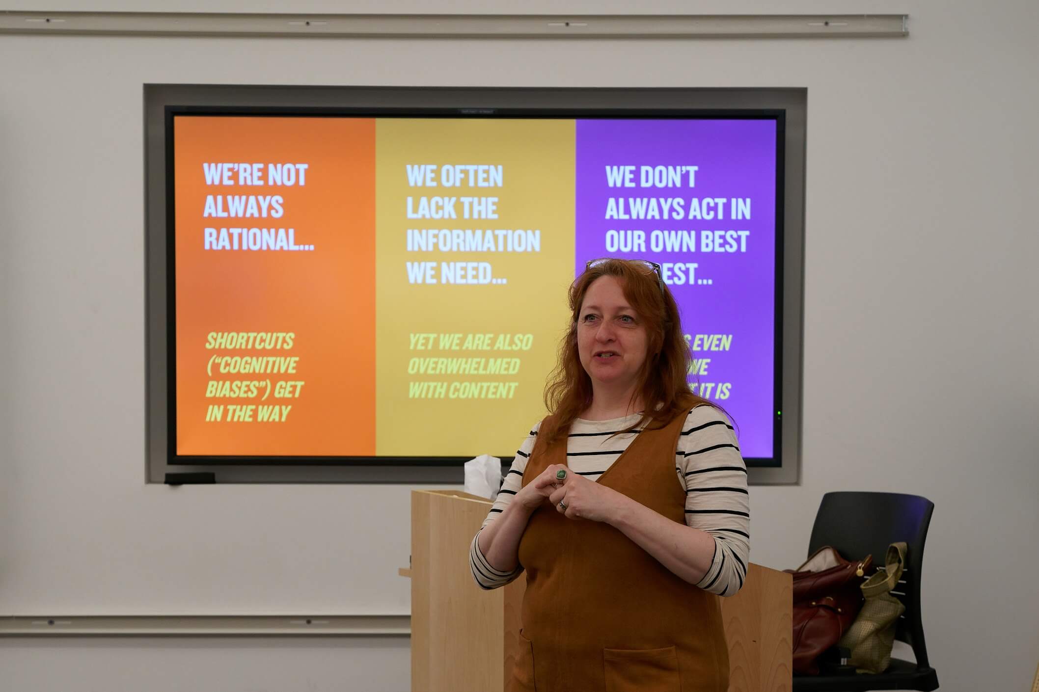 Ruth Schmidt presenting in front of a screen.