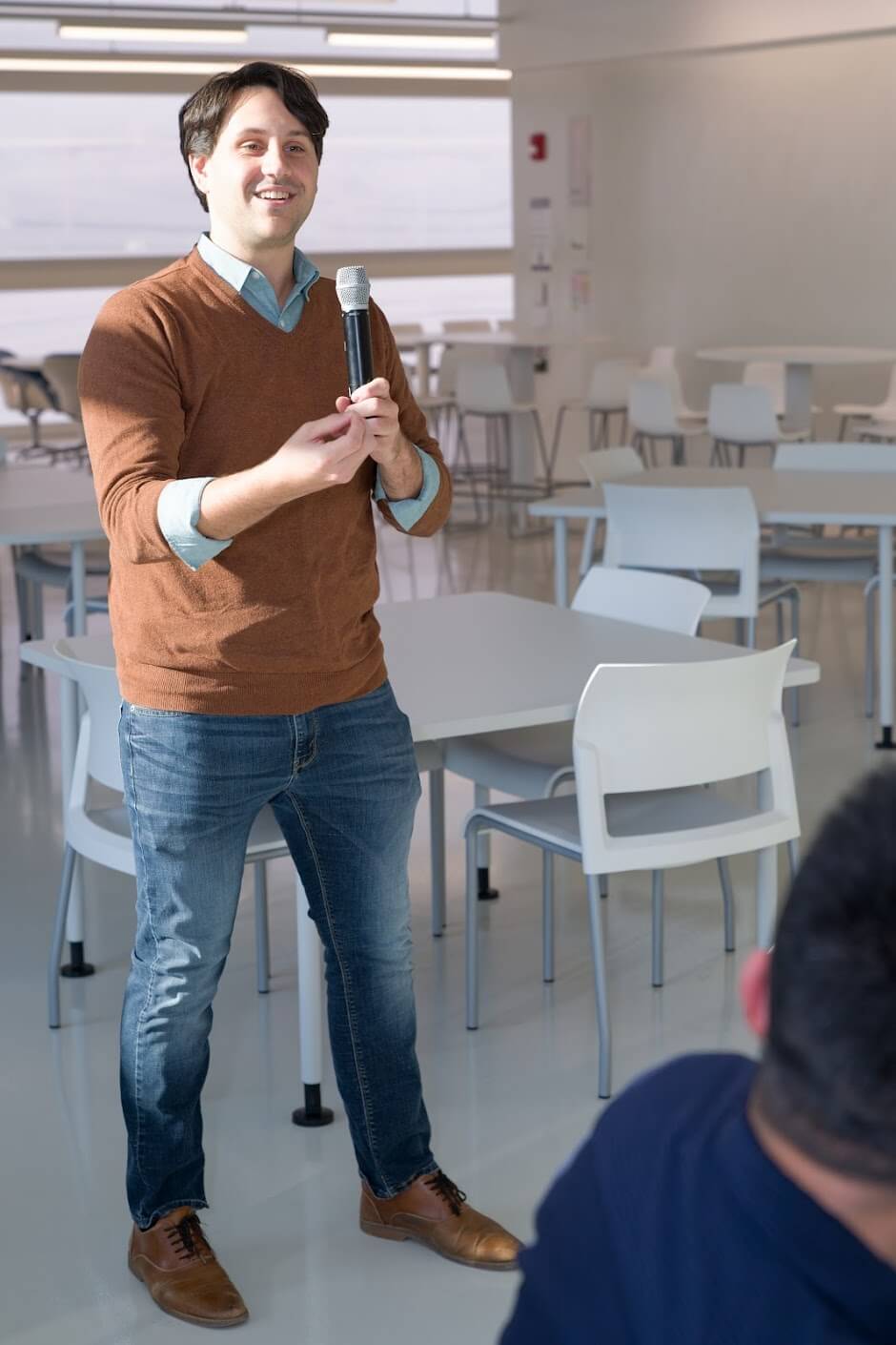 Zach Pino speaking with a microphone.